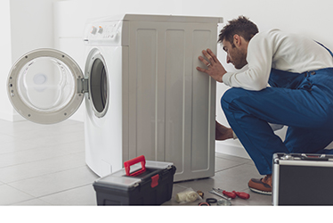 Professional repairman fixing a washing machine